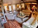 Cozy living room with hardwood floors, comfortable seating, and lots of natural light at 3919 Evans Rd, Cumming, GA 30040