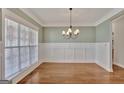 Bright dining room with wainscoting and hardwood floors at 90 Barrington Grange Dr, Sharpsburg, GA 30277