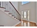 Hardwood floors, an elegant staircase, and a glass door at 90 Barrington Grange Dr, Sharpsburg, GA 30277