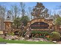 The Country Hills Estates entrance features stonework, statues and landscaping at 465 Belada Blvd, Sandy Springs, GA 30342