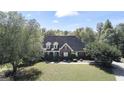 Large brick home surrounded by lush green trees at 168 Robson Trl, Mcdonough, GA 30252