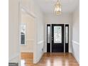 Elegant entryway with hardwood floors and a black door with glass accents at 168 Robson Trl, Mcdonough, GA 30252