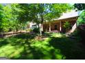 Landscaped backyard with a large tree and privacy fence at 900 Eskew Rd, Mcdonough, GA 30252