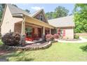 Brick home with a covered porch and stone accents at 900 Eskew Rd, Mcdonough, GA 30252