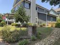 Side view of a gray house with a rock pathway and landscaping at 10 Plum Blossom Ln, Hampton, GA 30228