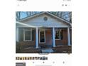 Brick ranch house with covered porch and columns at 6045 Winview Dr, Forest Park, GA 30297