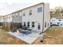 Private patio with concrete slab, fire pit, and seating area at 4937 Lower Elm St, South Fulton, GA 30349