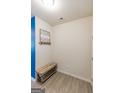 Small entryway with wood bench, wall hooks, and blue accent wall at 4937 Lower Elm St, South Fulton, GA 30349