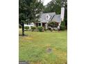 Two-story house with mature trees and landscaping in the front yard at 161 Revolutionary Dr, Hampton, GA 30228
