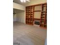 Living room with fireplace and built-in wooden shelving unit at 161 Revolutionary Dr, Hampton, GA 30228