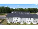 Back view of modern townhomes showcasing backyard patios and landscaping at 325 Sound Cir # 137, Stockbridge, GA 30281