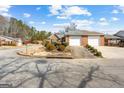 Street view of a well-maintained single-story brick home with an attached two-car garage and landscaped front yard at 180 Lagrange Ct, Fayetteville, GA 30214