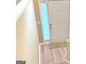 Inviting entryway with light wood floors and a modern front door at 62 Haver Dr, Riverdale, GA 30274