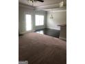 Bright living area with carpet flooring, with view into the dining area and the outdoor access door at 284 Madison Grace Ave, Mcdonough, GA 30252