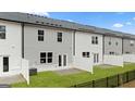 Townhome backyard featuring manicured lawn, small concrete patio, and privacy fence at 321 Sound Cir # 138, Stockbridge, GA 30281