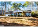 Brick ranch home with attached garage and landscaped yard at 1391 Lakeview Pkwy, Villa Rica, GA 30180