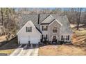 Two-story house with stone accents and a two-car garage, aerial view at 106 Old Gettysburg Way, Dallas, GA 30157