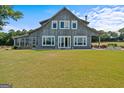 Gray barn style home with a large yard and porch at 3170 Double Bridges Rd, Rutledge, GA 30663