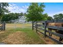 Home exterior view with a horse behind a fence at 3170 Double Bridges Rd, Rutledge, GA 30663