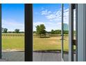 Open french doors looking out onto a large green field at 3170 Double Bridges Rd, Rutledge, GA 30663