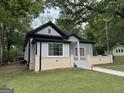 Charming grey house with black trim and inviting front porch at 1771 Ware Ave, East Point, GA 30344