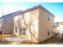 Tan brick home with a patio and backyard at 11958 Quail Dr, Hampton, GA 30228