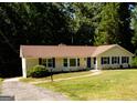 Single-story home featuring manicured front yard and walkway to entry at 2751 Colonial Dr, College Park, GA 30337