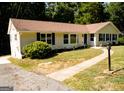 Well-maintained single-story home with a concrete driveway and sidewalk at 2751 Colonial Dr, College Park, GA 30337
