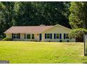 Charming single-story home with blue shutters and a well-manicured lawn at 2751 Colonial Dr, College Park, GA 30337