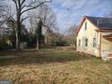 Large backyard with mature trees and a storage building at 41 W Main St, Hampton, GA 30228