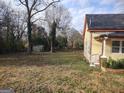 Spacious backyard with mature trees and a storage shed at 41 W Main St, Hampton, GA 30228
