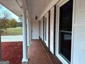 Covered porch with columns and tile flooring at 1351 John Robert Dr, Morrow, GA 30260