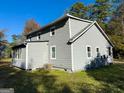 Gray house with white trim, sunroom, and AC unit at 5125 2Nd St, Morrow, GA 30260