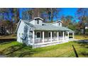 Gray house with white trim, a porch, and satellite dishes at 5125 2Nd St, Morrow, GA 30260
