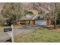 Charming brick home with blooming trees and a well-manicured lawn at 25 Brookstone Ct, Covington, GA 30016