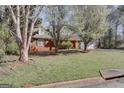 A lush front yard with mature trees surrounding this brick home at 25 Brookstone Ct, Covington, GA 30016