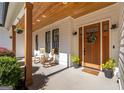 Inviting front porch with rocking chairs, wood columns, and a craftsman-style front door at 9770 Coleman Rd, Roswell, GA 30075