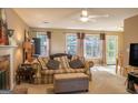 Living room with fireplace, sofa, and large windows at 245 Mckenzie Dr, Stockbridge, GA 30281