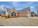 Brick house with attached garage and landscaping at 105 Parks Pl, Sharpsburg, GA 30277