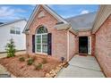 Brick house with black front door and landscaping at 105 Parks Pl, Sharpsburg, GA 30277