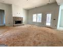Spacious living room with a brick fireplace and a door leading to the backyard at 4601 Parkwood Rd, Social Circle, GA 30025