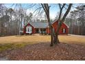Red brick house with a covered porch and a yard with some trees at 55 Rainey Ridge Dr, Oxford, GA 30054