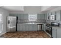Renovated kitchen with light gray cabinets and stainless steel appliances at 625 Armitage Way, Stockbridge, GA 30281