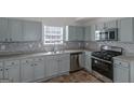 Renovated kitchen with light gray cabinets and stainless steel appliances at 625 Armitage Way, Stockbridge, GA 30281