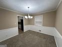 Bright dining room with chandelier and neutral color palette at 3780 Cedar Hurst Way, South Fulton, GA 30349