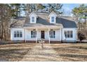 White two-story house with front porch and landscaping at 295 W 5 Hwy, Roopville, GA 30170