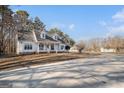 White house with a large yard and long driveway at 295 W 5 Hwy, Roopville, GA 30170