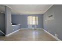 Spacious living room with light gray walls and wood-look flooring at 6665 Cedar Hurst Trl, College Park, GA 30349