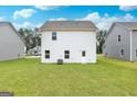 Spacious backyard with green grass and a white two-story house at 450 Prescott Way, Villa Rica, GA 30180