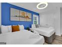 Spacious bedroom with two beds and a blue accent wall at 1081 Veltre Sw Cir, Atlanta, GA 30311